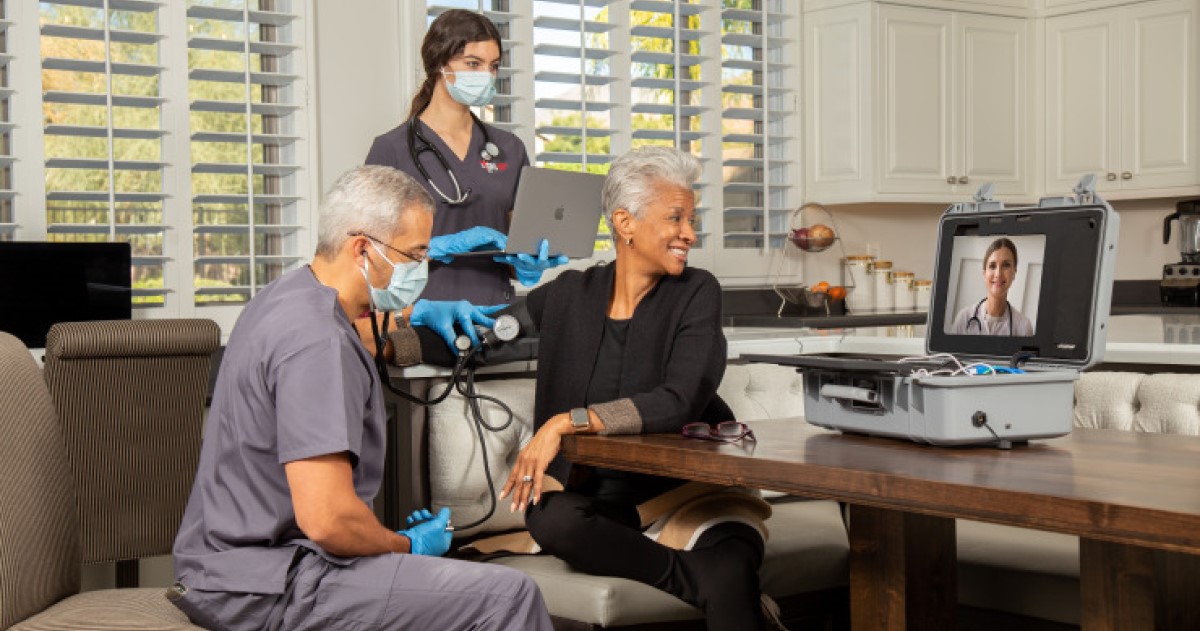 A home health visit with a screen on a table