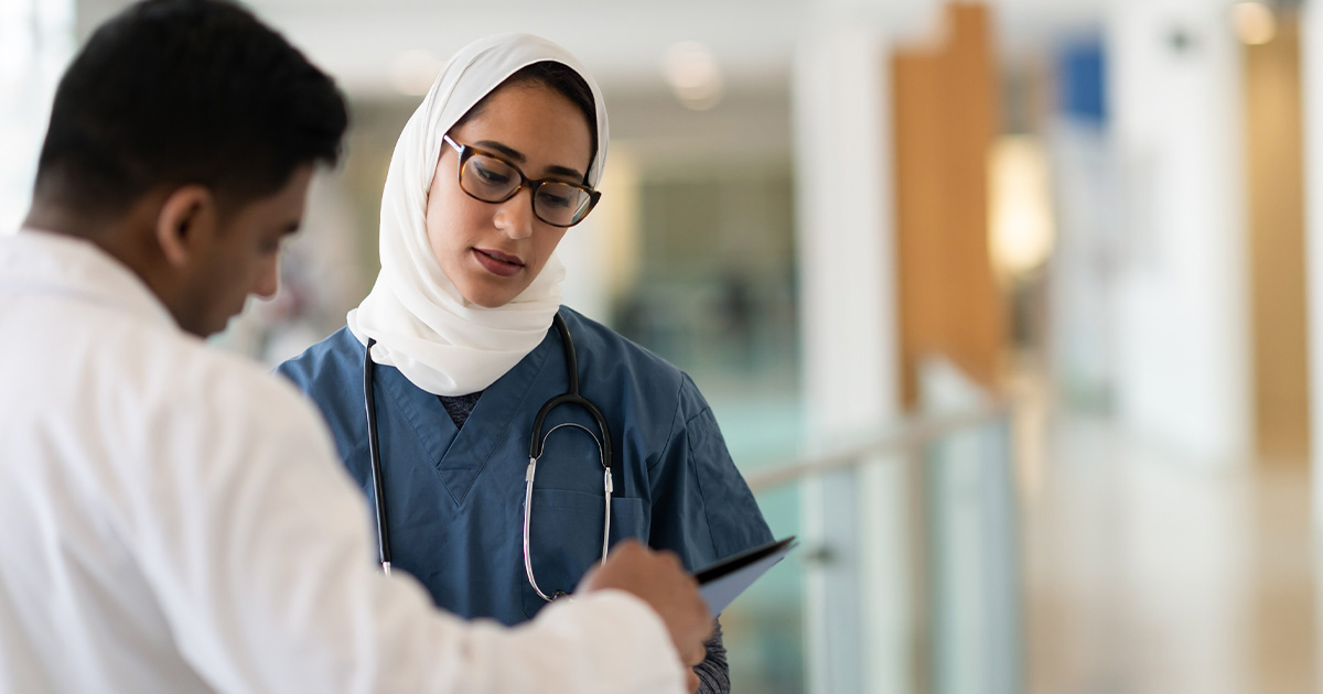Two healthcare workers talking in a hospital