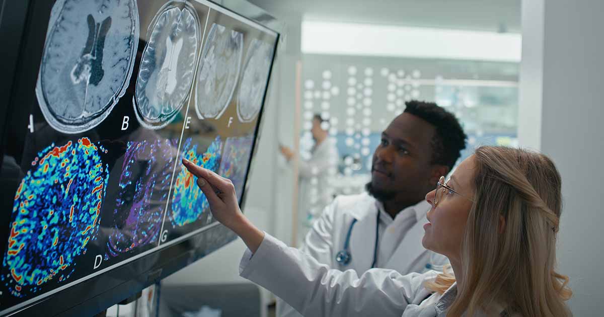 Healthcare workers looking at x-ray images on a monitor