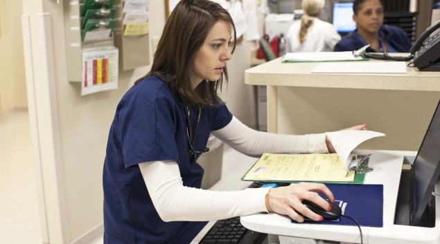 Healthcare worker working on a computer in hospital setting