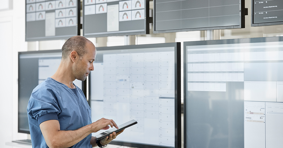 Person in scrubs with tablet