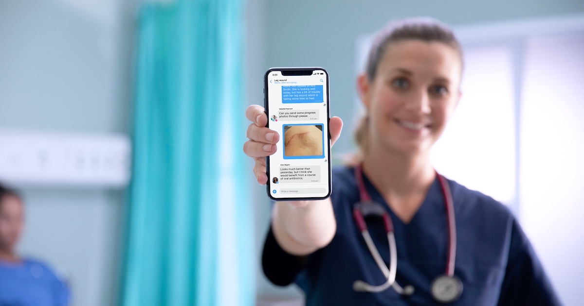 A nurse holding a mobile phone showing the Celo Health app