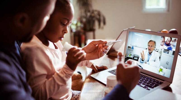 Child and parent attending telehealth appointment