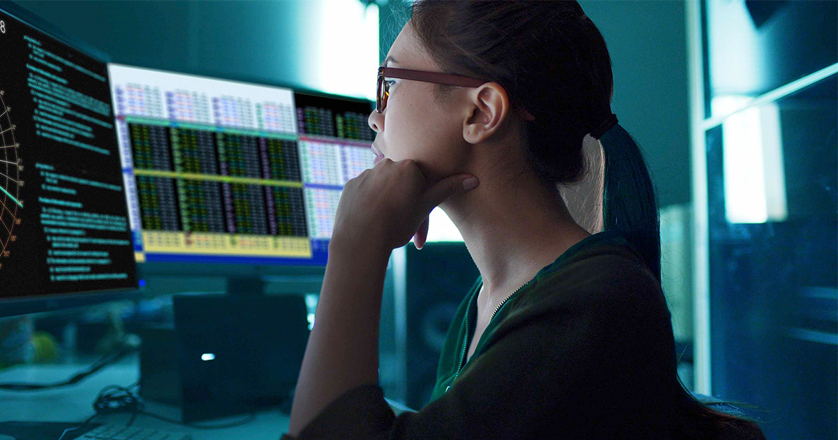 Worker looking at dual monitor