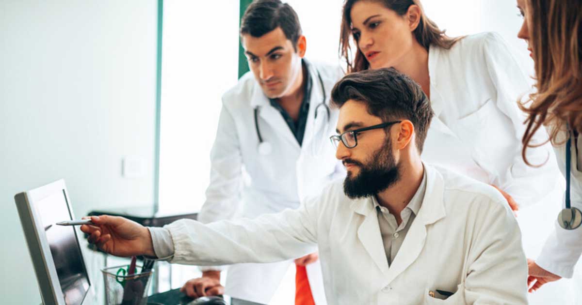 doctors looking at patient information on a computer