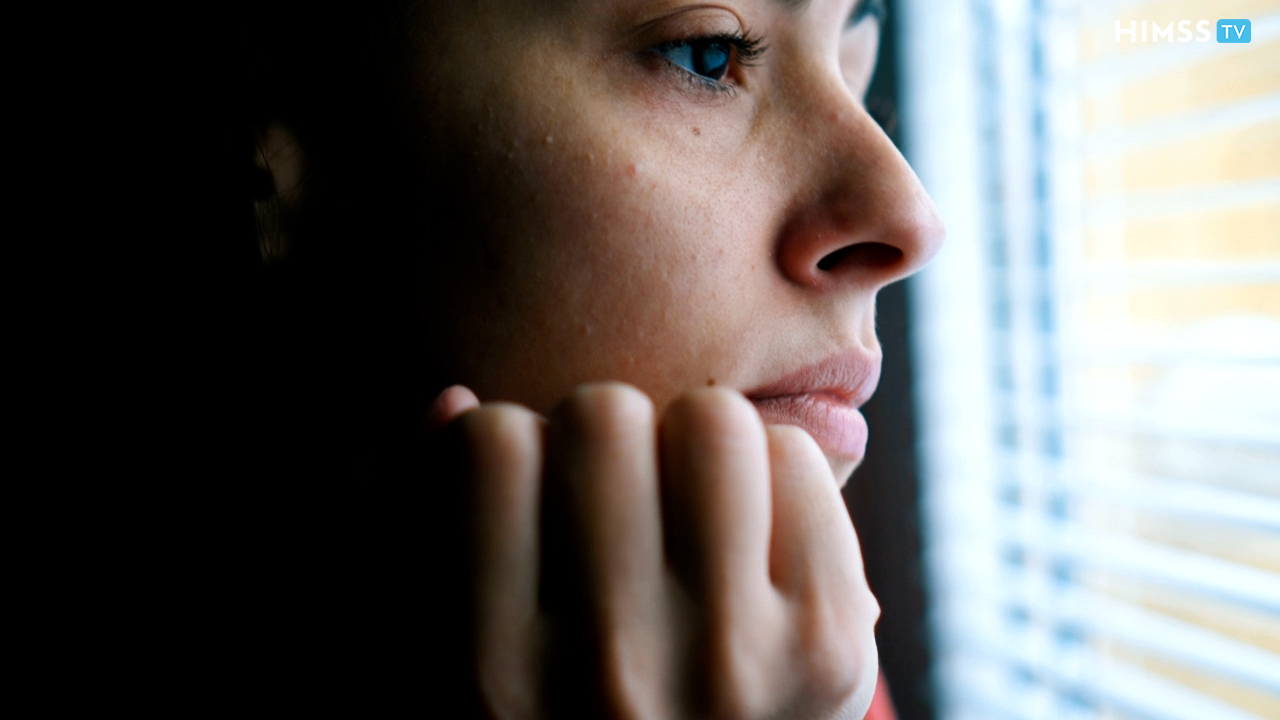Concerned person looking out of window
