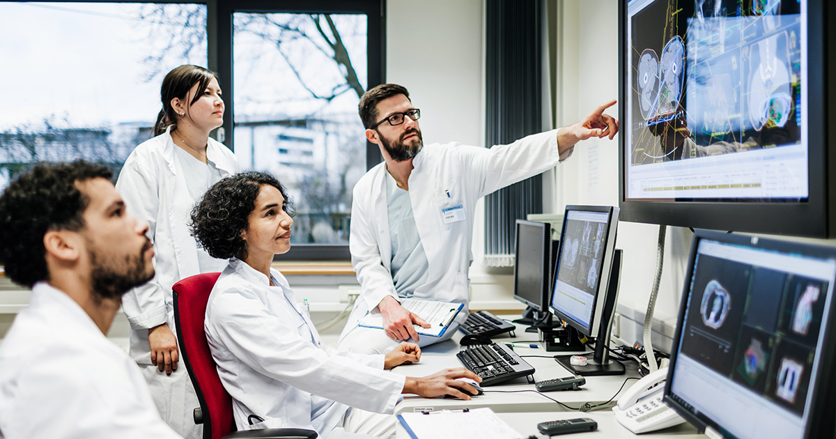 Healthcare workers pointing at a medical image on a display