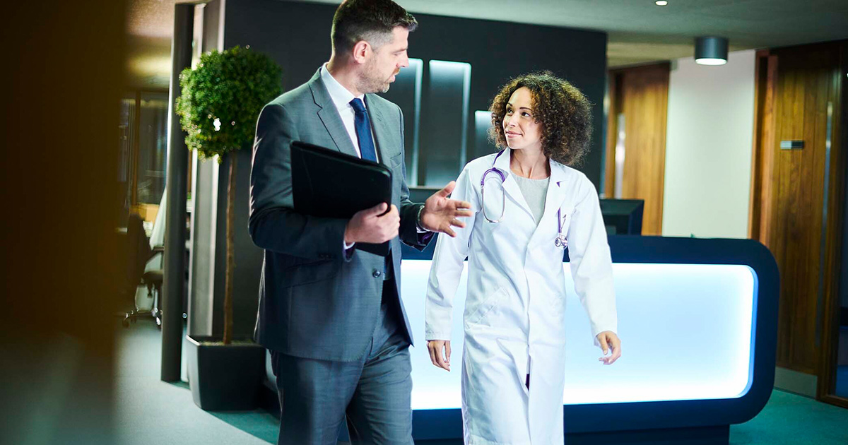 Doctor talking to business person