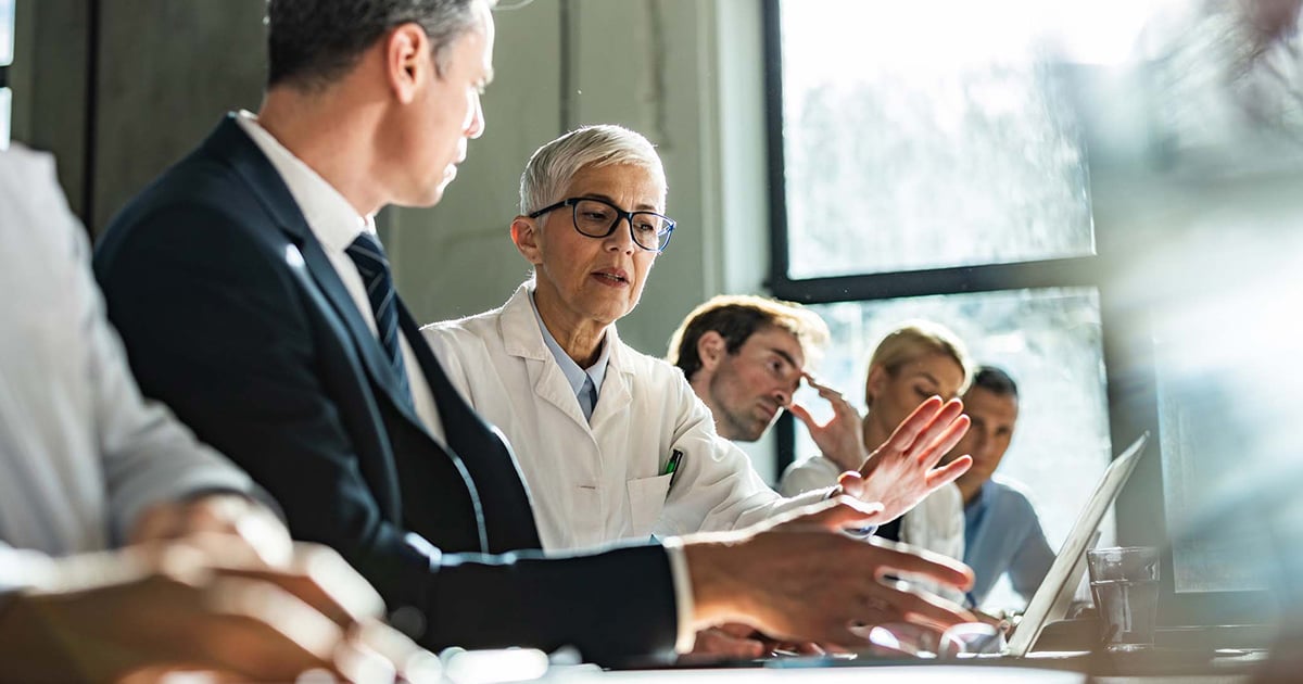 Doctor talking to executives