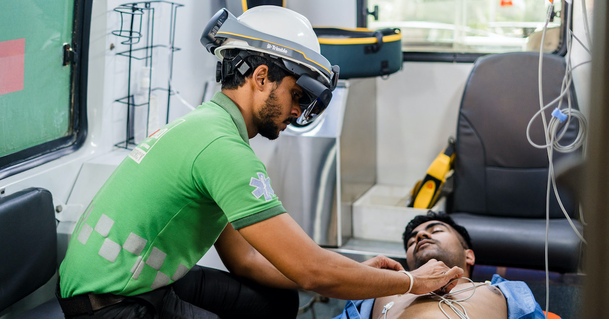 An emergency medical technician using the Microsoft HoloLens to locate areas for ECG Probe Placement in a patient
