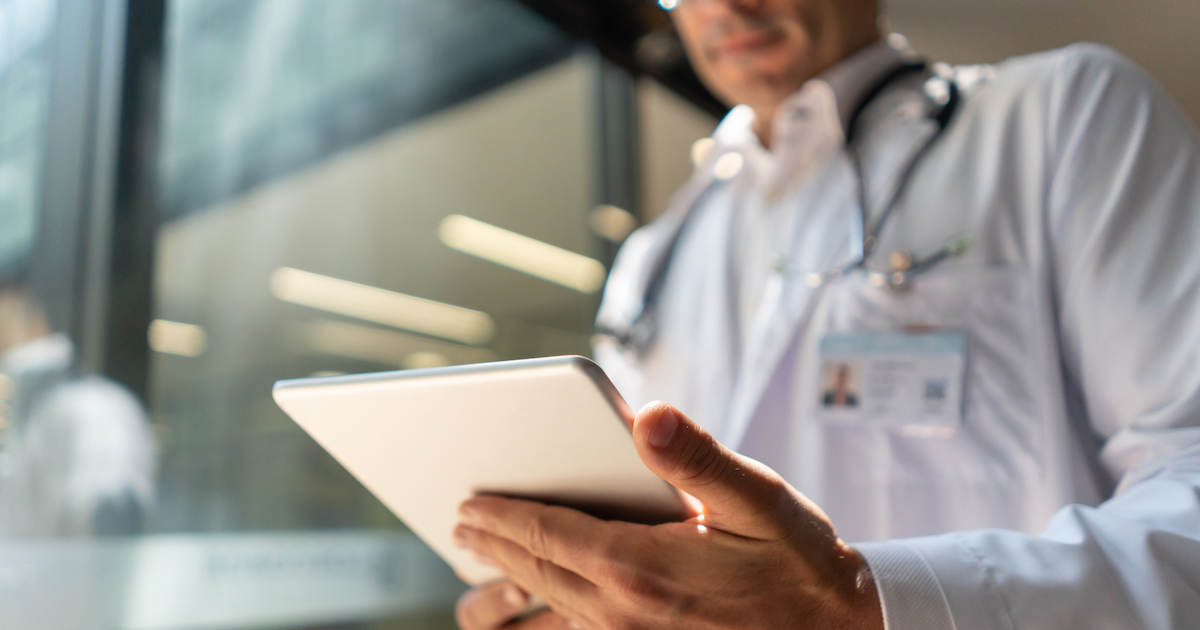 Doctor looking at a patient chart on a digital tablet