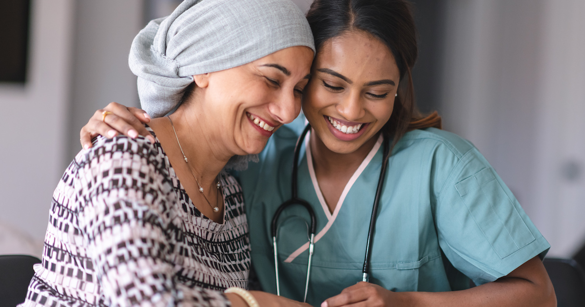 Cancer patient embracing healthcare worker
