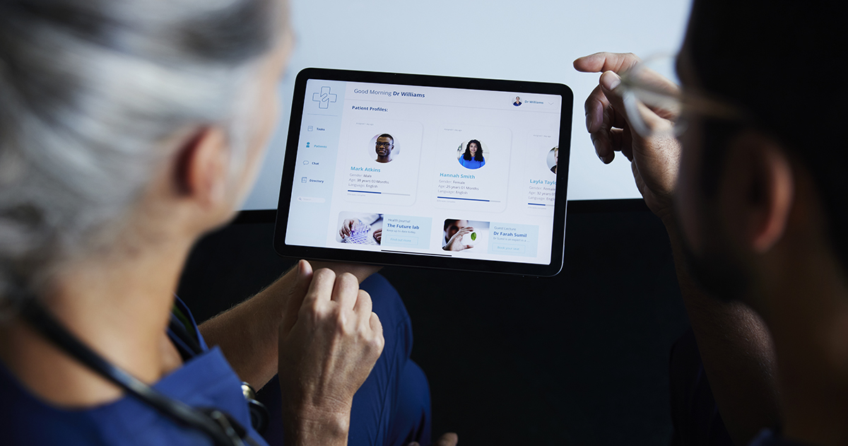 Healthcare workers looking at scheduling app on a tablet