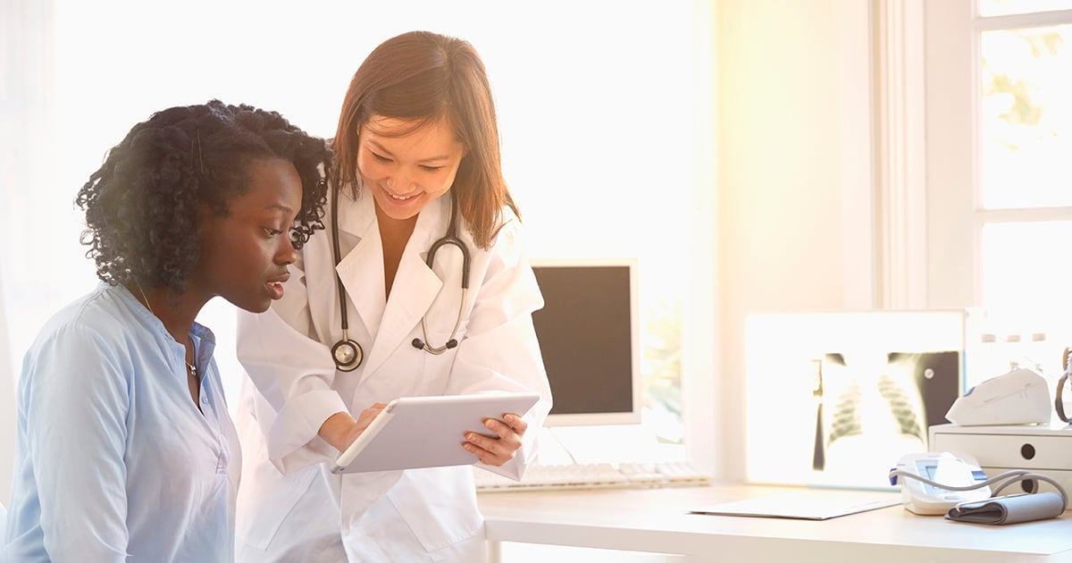 Doctor showing patient tablet