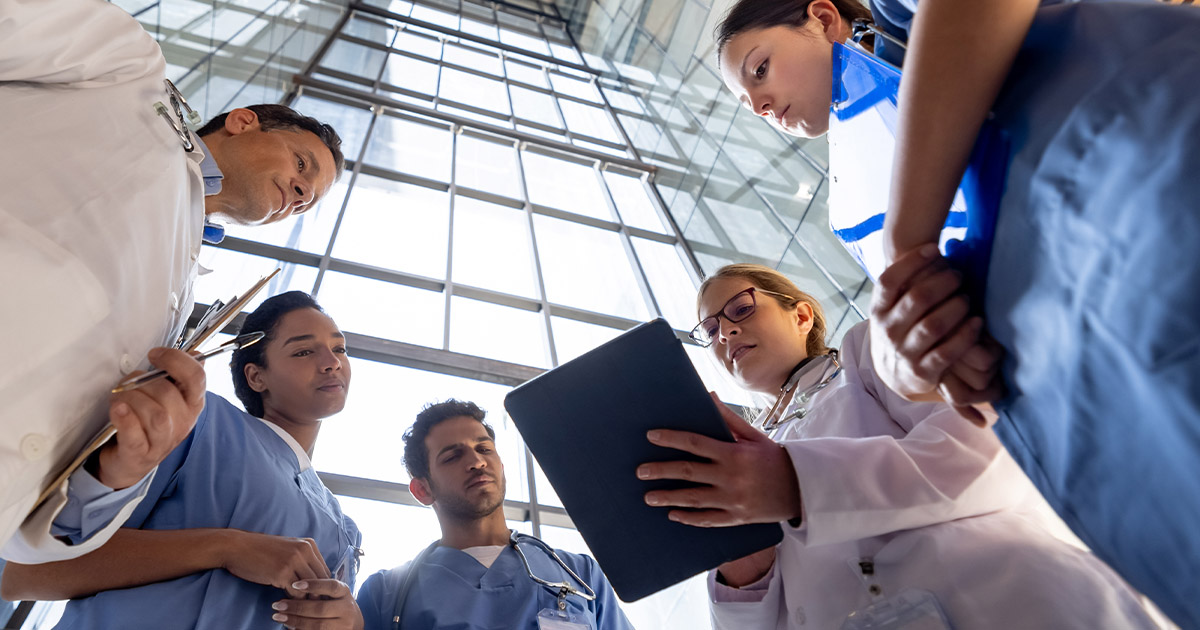 Clinicians reviewing information on a tablet