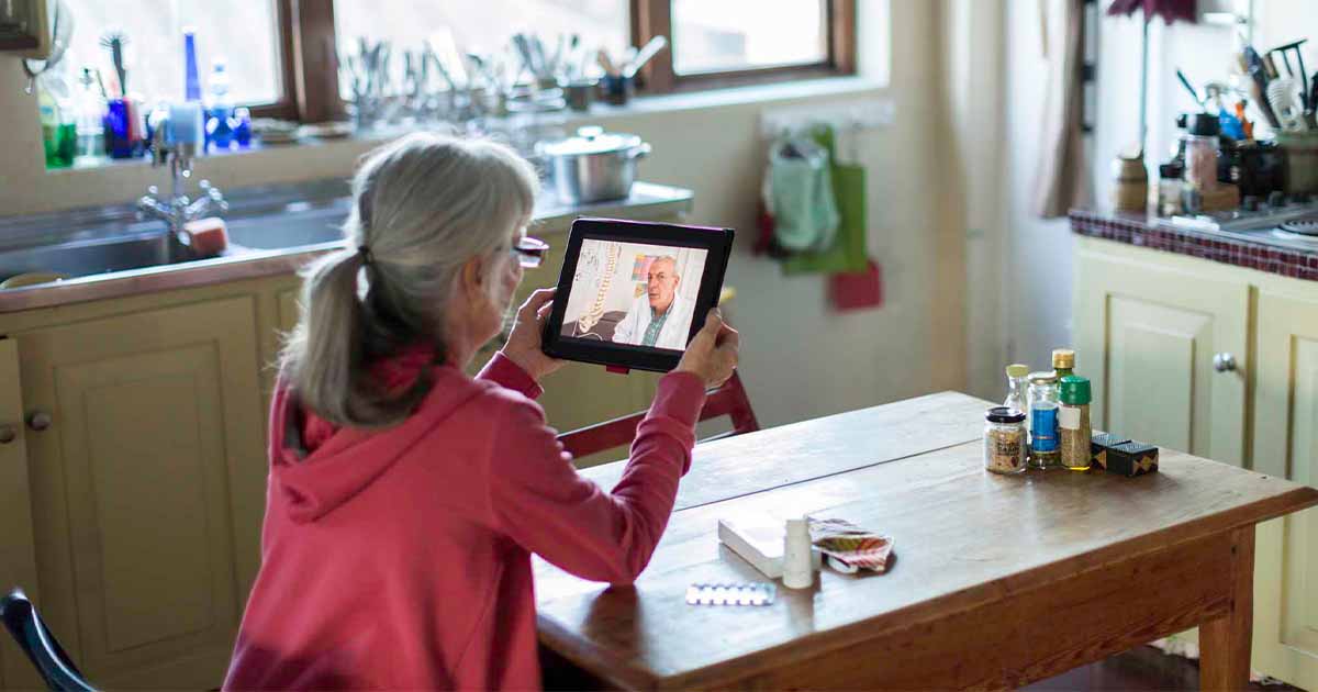 Person talking to a doctor on a tablet screen