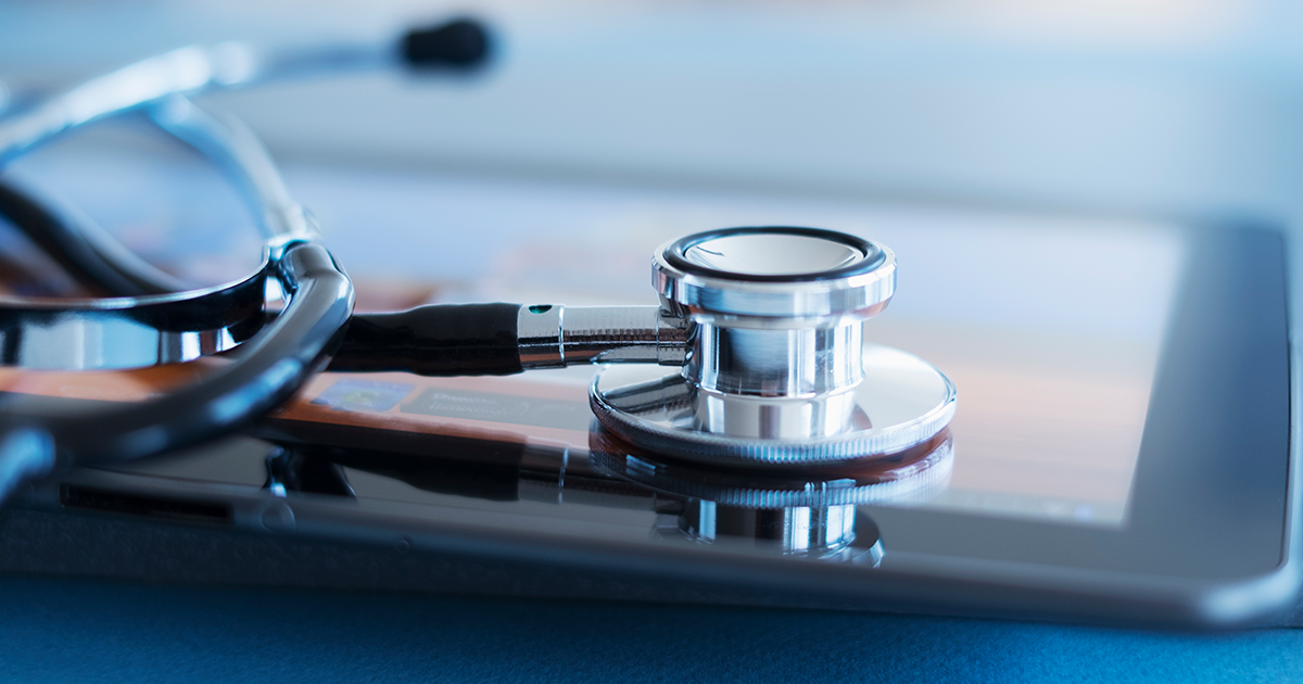 A stethoscope resting on a tablet