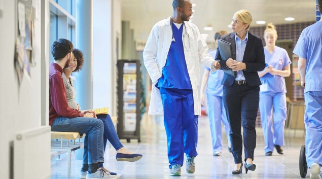 Medical staff walking down hospital hallway