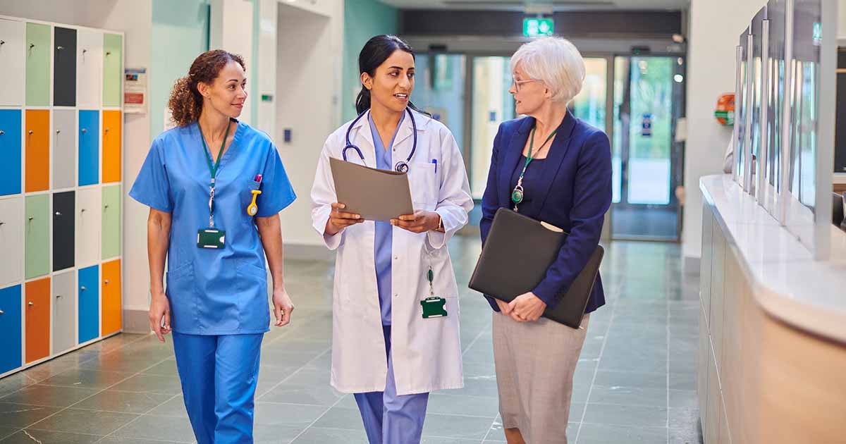 Healthcare workers talking in hallway