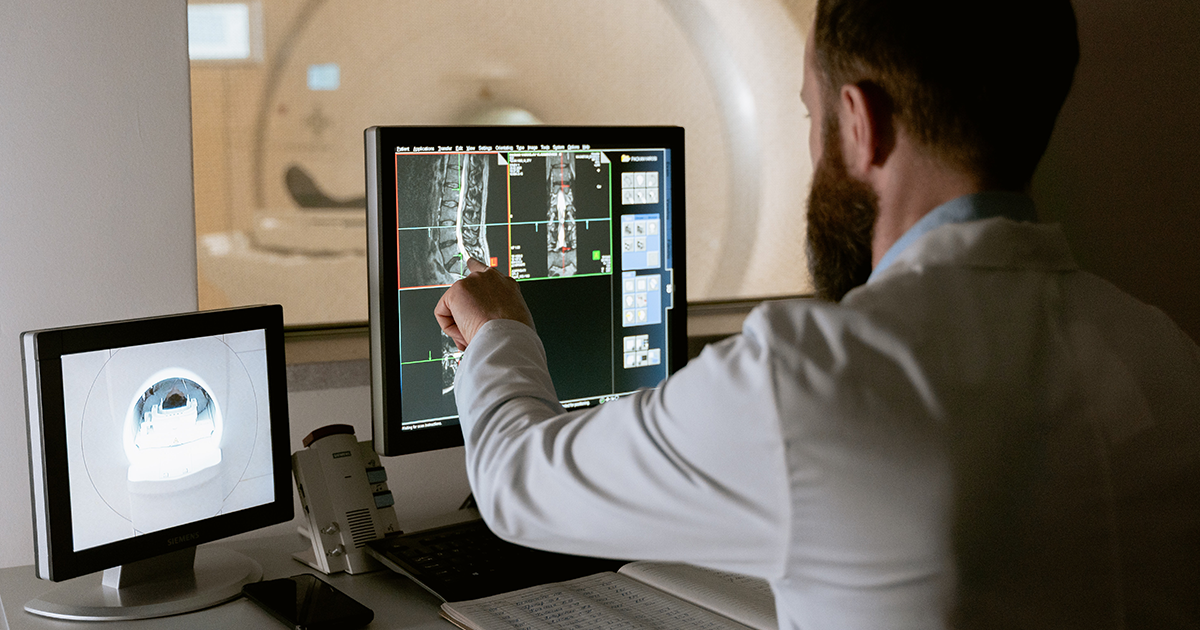 Person examines medical images on a screen