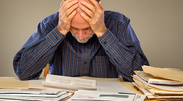Distressed senior with paperwork