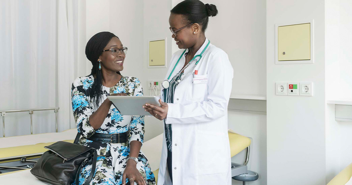 Doctor showing tablet to patient