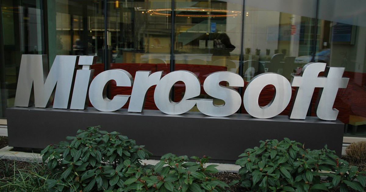 Microsoft sign in front of wide office window