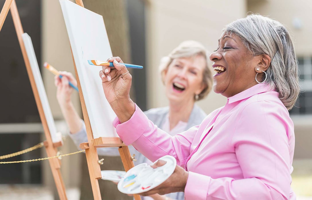 Laughing people painting