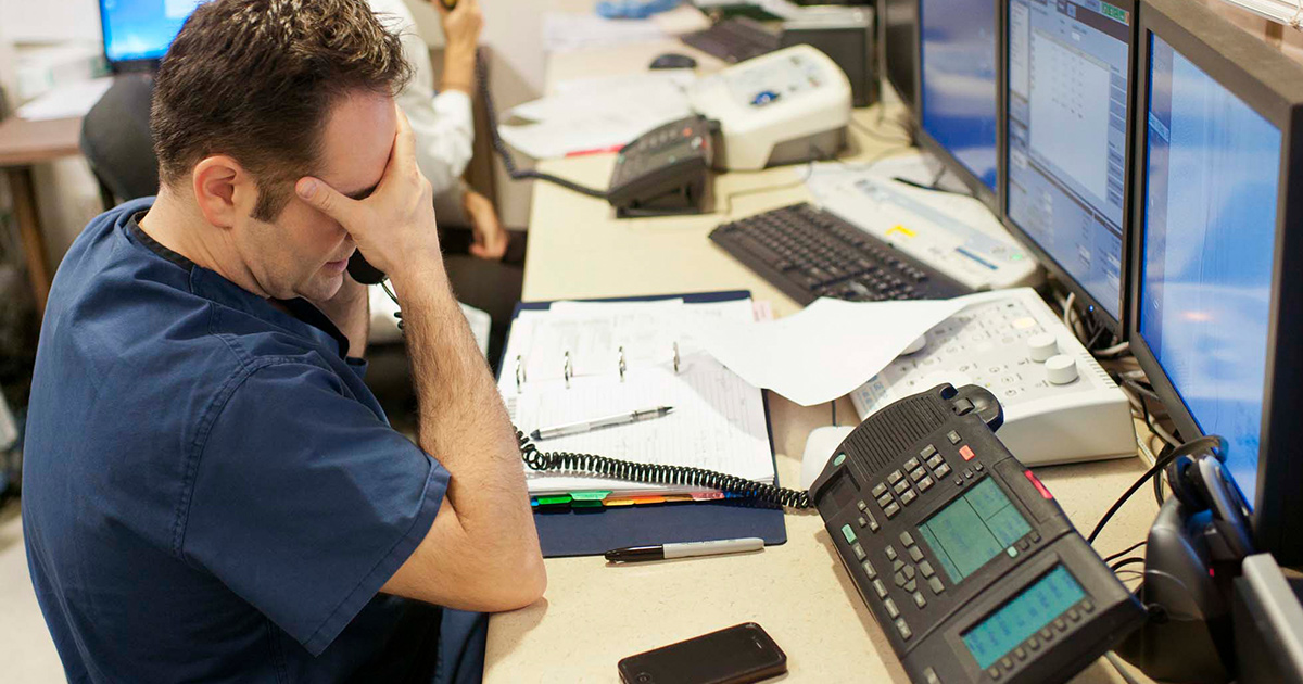 Stressed healthcare worker at a desk