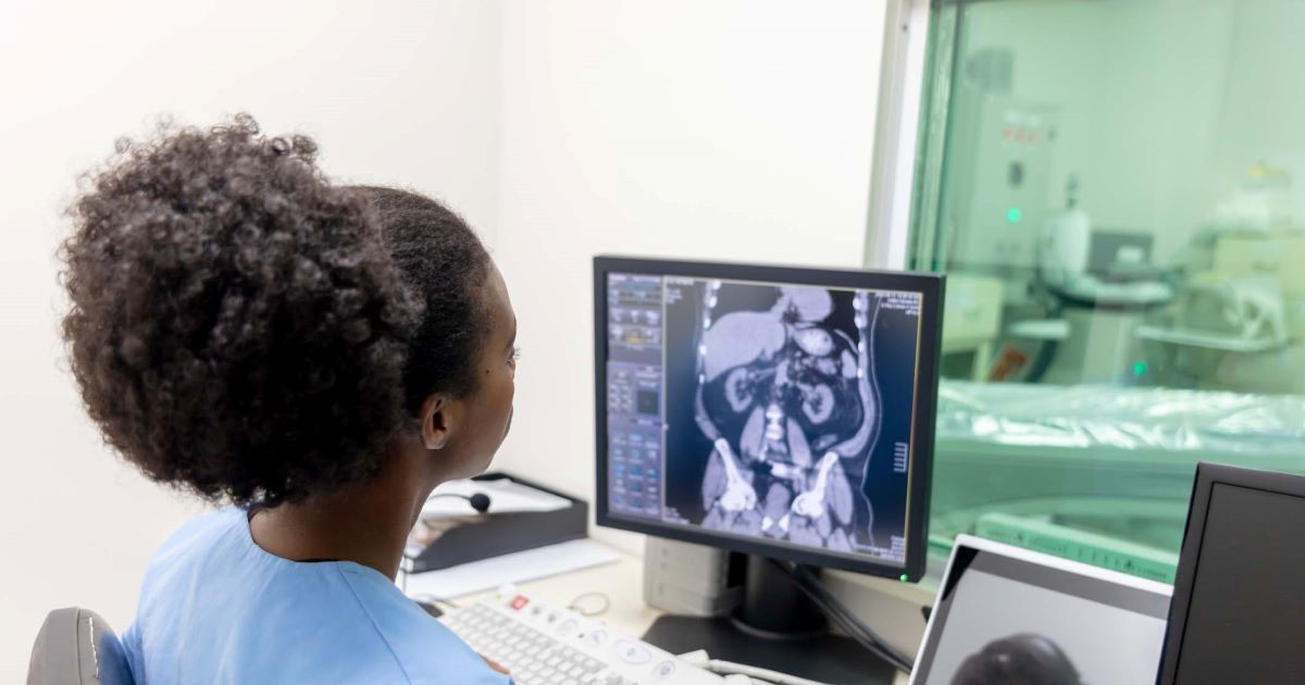 Healthcare worker looking at x-ray image on monitor