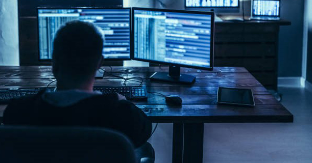 worker looking at dual monitors