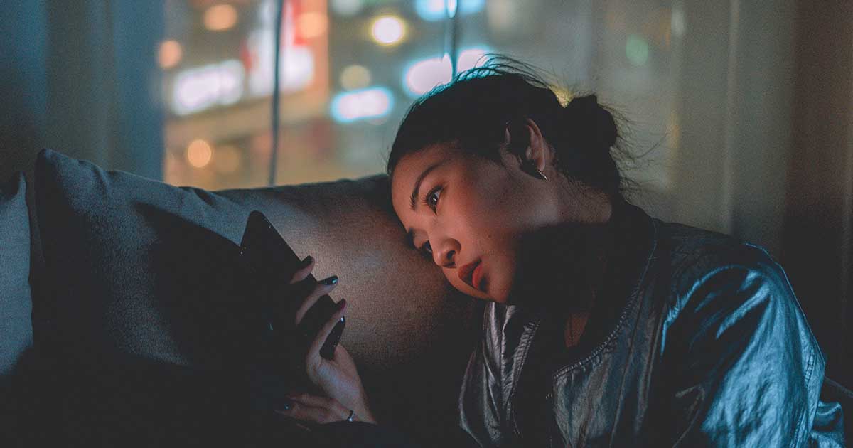Person with a smartphone on a couch