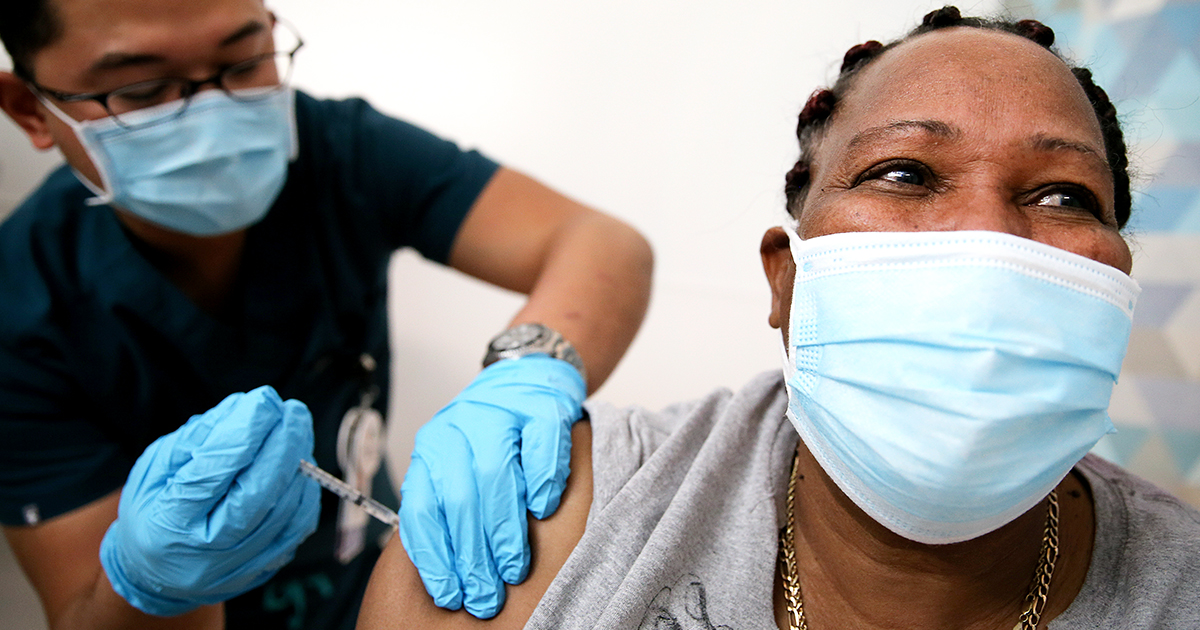 A COVID-19 vaccine is administered