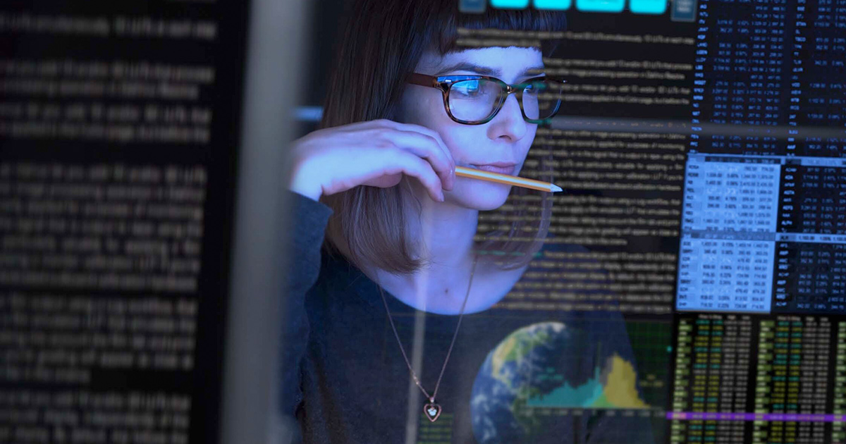 Worker looking at computer code display
