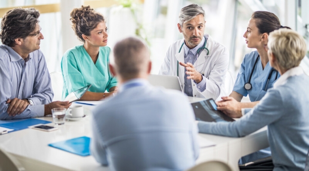 Healthcare workers meeting with business people
