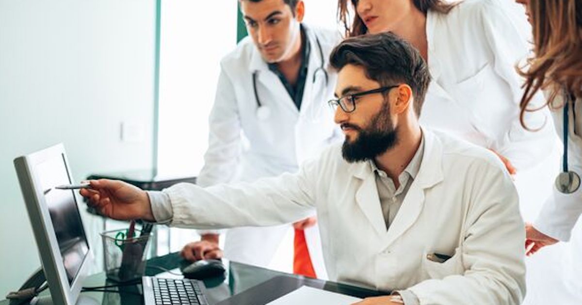 clinicians looking at a laptop screen