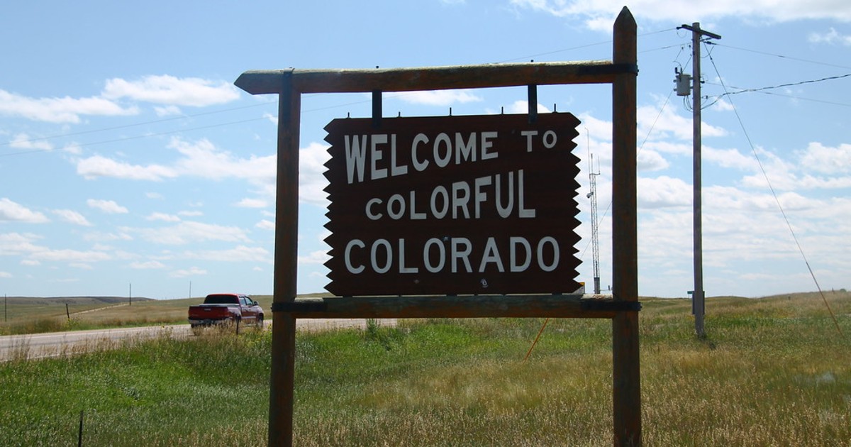 A sign reading "Welcome to Colorful Colorado"