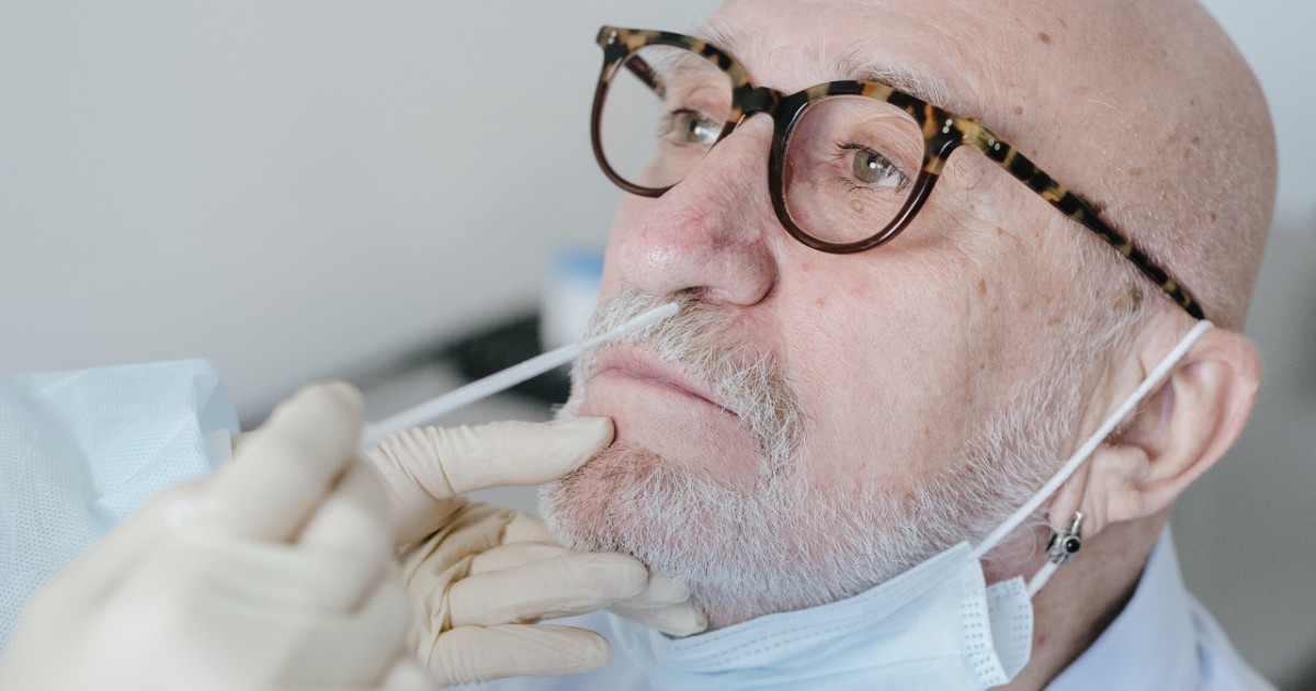 A person getting tested for COVID-19 with a nose swab