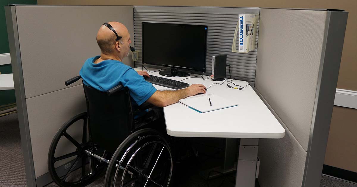 Person in wheelchare at office desk