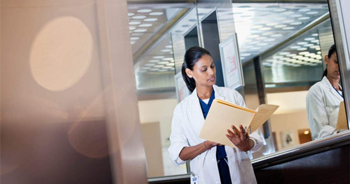 Doctor reviews information in a folder