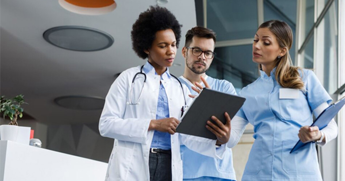 Clinicians look at a tablet