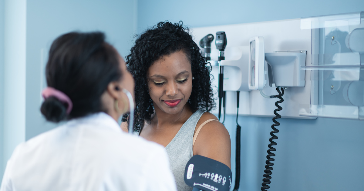 Doctor and patient with blood pressure cuff