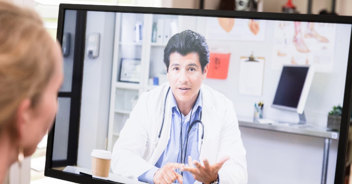 A patient speaking with their doctor via telehealth
