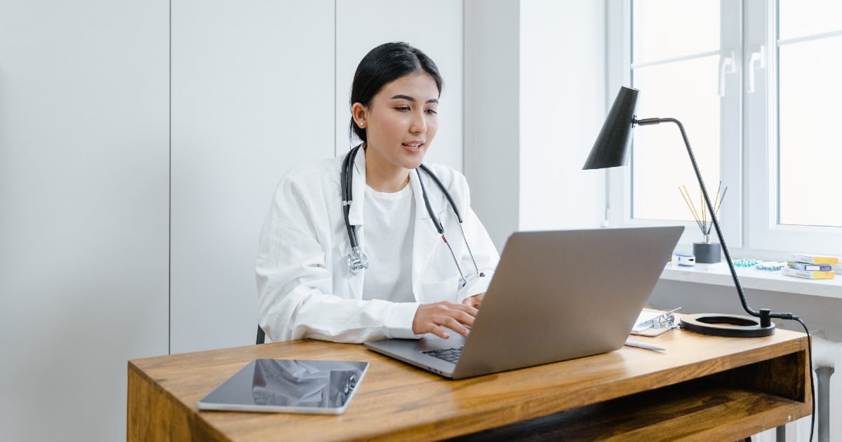 A medical professional at a computer