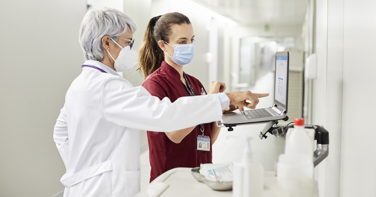 Doctor and nurse look at data on a hospital computer