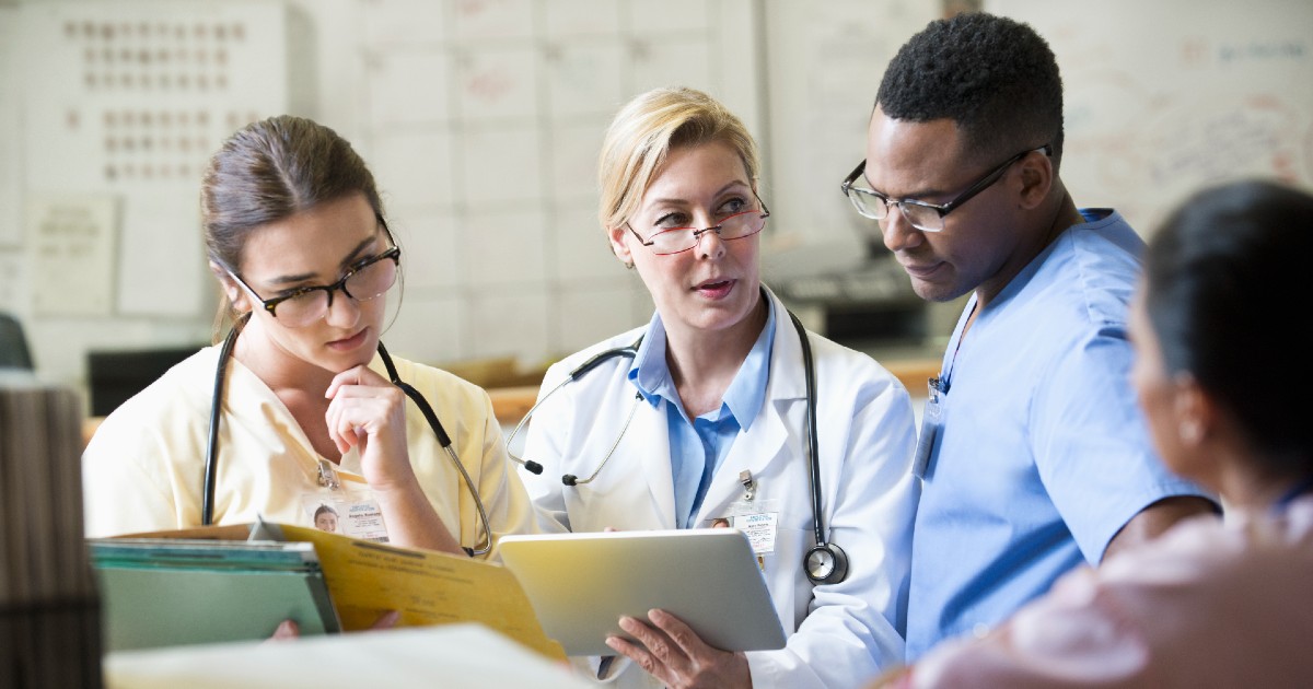 A team of medical staff with a digital tablet