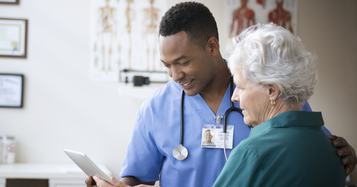 Doctor helping patient with tablet