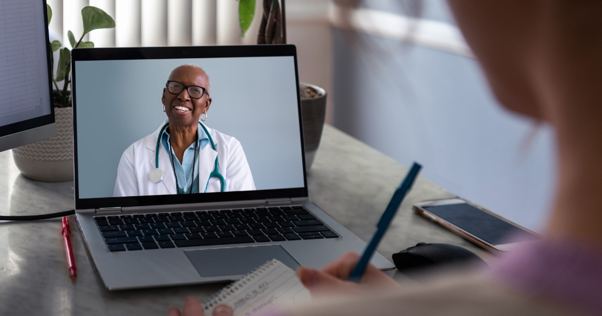 A doctor consults with a patient via video