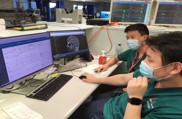 Healthcare staff looking at a computer.