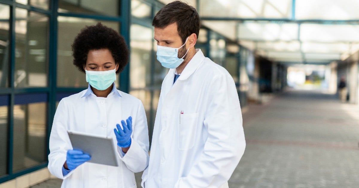 doctors looking at a tablet